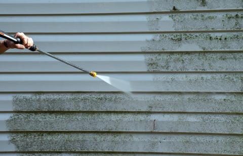 House vinyl siding being pressure washed