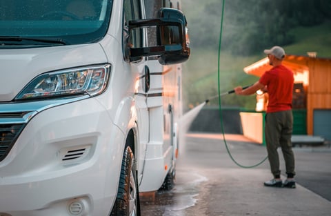 Camper van being washed with water spray